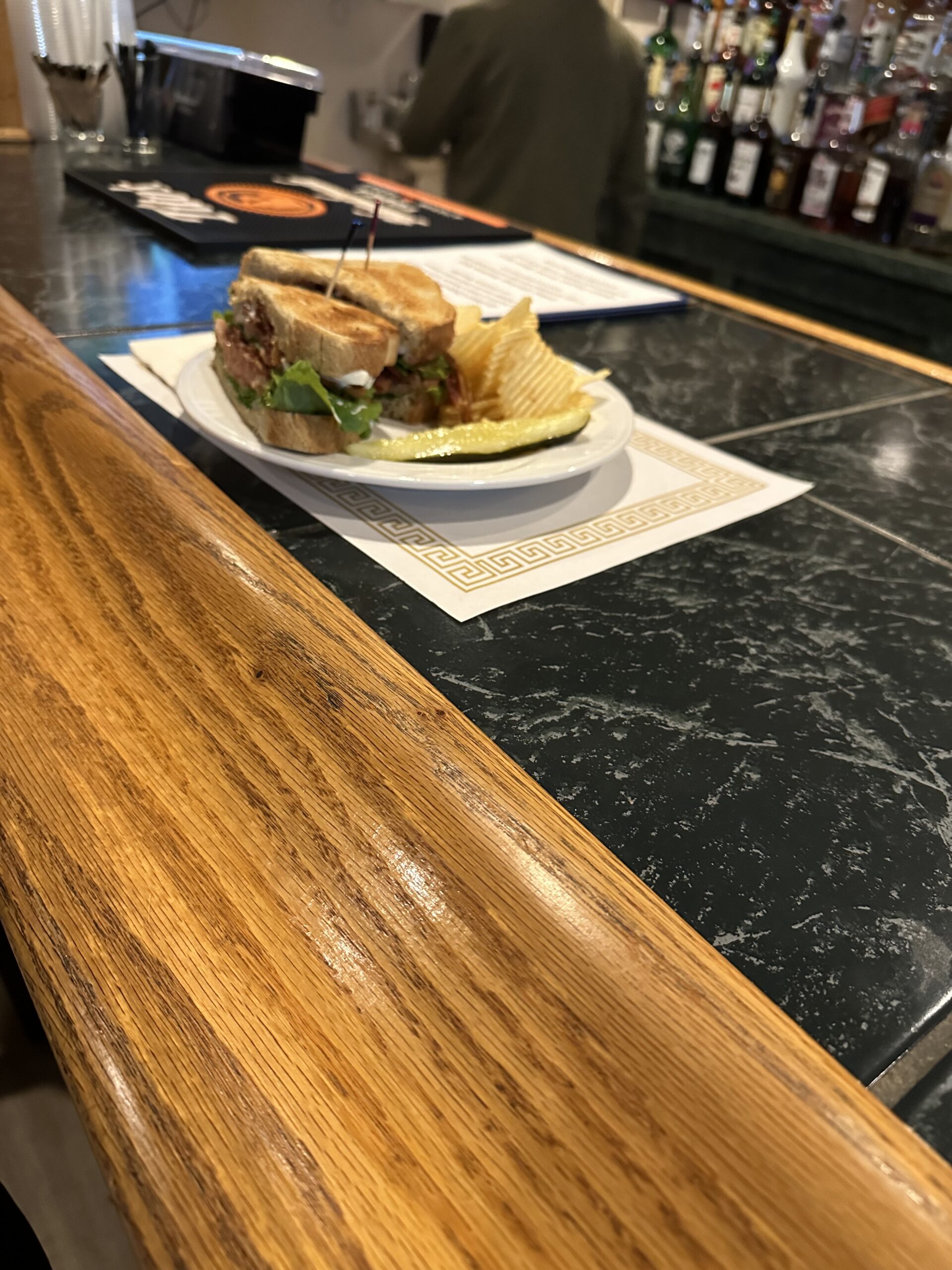 A sandwich with chips and a pickle served at the Rathskeller bar.