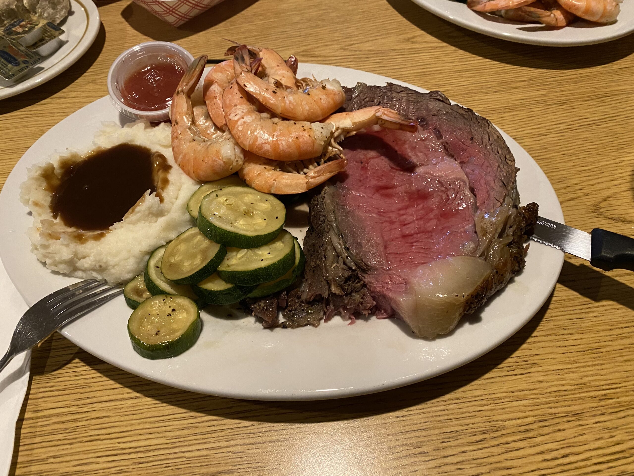 A Rathskeller dinner of sliced beef, shrimp, mashed potatoes and vegetables.